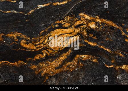 Natürliche orange-rote, schwarze, graue Marmortextur in der Nähe. Stockfoto