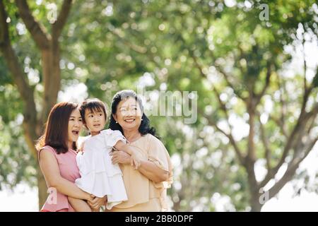 Glückliche drei Generationen von Frauen verbringen den Sommertag im Stadtpark Stockfoto