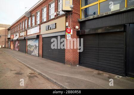Eine Reihe geschlossener Geschäfte am Montagmorgen, 8:00 Uhr, normalerweise geschäftige Pendlerzeit mit leeren Straßen am Ende der ersten Woche der Sperrung, Glengormley, Stockfoto