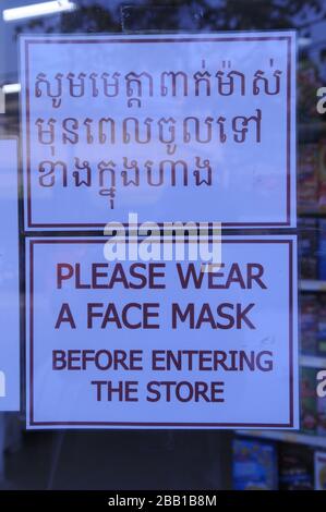 Ein Supermarkt zeigt während der Coronavirus Pandemie ein zweisprachiges Schild "Bitte tragen Sie eine Gesichtsmaske" an. Phnom Penh, Kambodscha. © Kraig Lieb Stockfoto