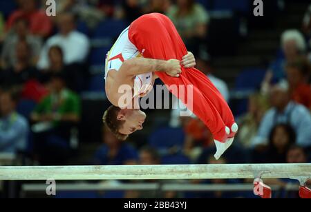 Der Rumäne Flavius Koczi tritt während der Qualifikation des Kunstturnierteams in der North Greenwich Arena in London an den Parallelbars an. Stockfoto