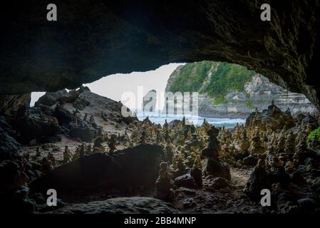 Geheimer Strand von Tembeling, in einem Dschungeltal und einem balinesischen Tempel, mit natürlichem Süßwasserpool und Kieselstrand in Nusa Penida, Bali, Indonesien Stockfoto