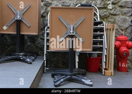 Tische und Chaises de bistrot entassées devant un Restaurant. Verwaltung von Fermetten. Coronavirus. Covid-19. Saint-Gervais-les-Bains. Savoie. Stockfoto