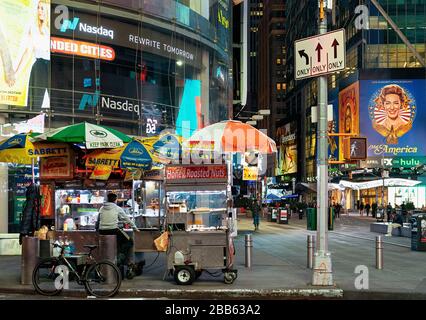 Ein Straßenhändler auf einem menschenleeren Times Square während der Hauptverkehrszeit und die Covid-19-Pandemie in New York City, New York. Stockfoto