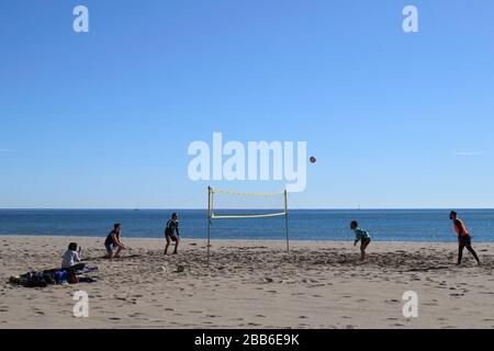 Volleyball. Eine Gruppe junger Männer, die Volleyball am Strand spielen, an einem schönen sonnigen Tag in Fuengirola, Spanien, Stockfoto