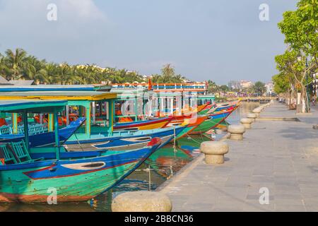 HOI AN, VIETNAM - 25. MÄRZ 2017: Bunte Ausflugsboote entlang der Küste und Thu Bon River in der Altstadt Hoi an am Morgen. Reflexionen Stockfoto