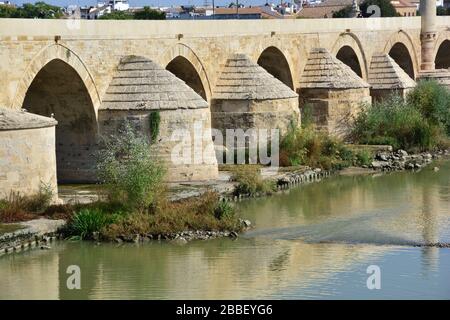 Cordoba, Spanien: Panoramablick auf lange, restaurierte Brücke mit vielen Arkaden und Torturm am Ende der Moschee-Kathedrale von Cor Stockfoto