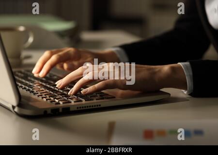 Nahaufnahme der Geschäftsfrau übergibt sich nachts im Büro das Tippen auf dem Laptop Stockfoto