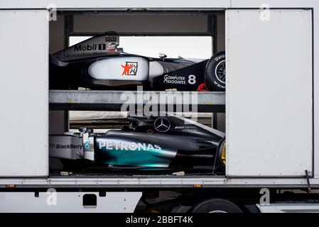 Zwei Formel-1-Rennwagen von Mercedes-Benz aus verschiedenen Jahren werden auf dem Goodwood Festival of Speed zum Entladen von einem Autotransporter umgekommenen. Stockfoto