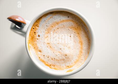 Tasse Kaffee mit cremiger Milch. Zenithale Ansicht. Stockfoto