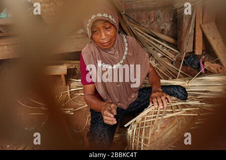 Bambuskorb Handwerkerin, während er seine Arbeit an einem Ort verrichten konnte Stockfoto