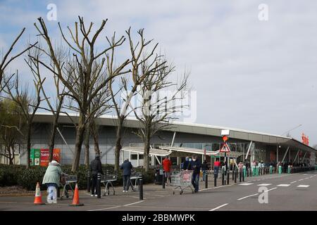 London, Großbritannien. April 2020. Käufer warten auf ihren Lebensmitteleinkauf vor Sainsburys in Beckton, East London. (Foto von Mitchell Gunn/Espa-Images) Credit: European Sports Photographic Agency/Alamy Live News Stockfoto