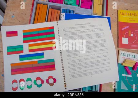 April 2020 Vintage Cuisenaire Holzzählstäbe und Begleitbücher mit mathematischen Herausforderungen, um das Lernen zu erleichtern Stockfoto