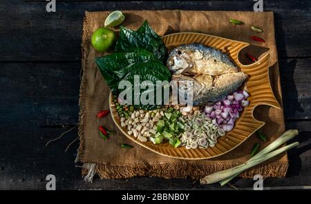 Traditionelle thailändische Essen: Gebratene Makrele serviert mit frischem Gemüse und Kraut, das Essen ist das thailändische Essen call Meuang Makrele (Maing-Pla-zu). Stockfoto