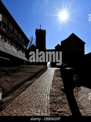 Eisenach, Deutschland. April 2020. Die Sonne scheint vom blauen Himmel über der fast menschenleeren Wartburg. Im Kampf gegen die Coronavirus-Pandemie will die Landesregierung die Kontaktbeschränkungen im öffentlichen Raum in Thüringen bis zum 19. April ausweiten. Kredit: Martin Schutt / dpa-Zentralbild / dpa / Alamy Live News Stockfoto