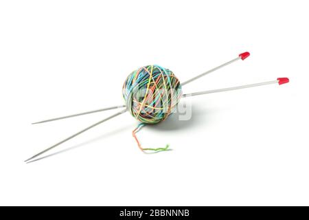 Ball with multi-colored woolen threads and knittings stuck into it Stockfoto