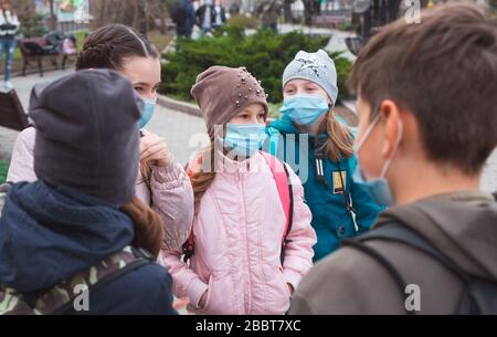 Stadtbewohner Erwachsene und Kinder beobachten Quarantäne und gehen in Masken Stockfoto