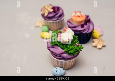 Easter Food Konzept. Idee für Kinder. Dekorieren Sie Osterhase Cupcakes mit Meringues. Stockfoto