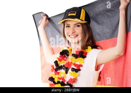 Attraktive junge Frau mit Fanartikeln für Deutschland, Deutschland bei einer Sportveranstaltung Stockfoto