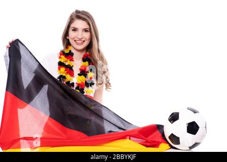 Attraktive junge Frau mit Fanartikeln für Deutschland, Deutschland bei einer Sportveranstaltung Stockfoto