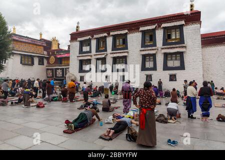 Pilger beten vor dem Jokhang-Tempel an. Der buddhistische Tempel auf dem Barkhor-Platz gilt als der heiligste und wichtigste Tempel Tibets. Stockfoto