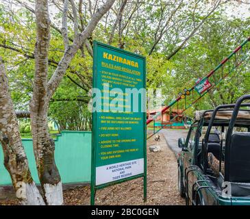 Green Gypsy Safari Vehicle Waiting by a Rules and Regulation sign in the morning at the infor to Kaziranga National Park, Assam, Northeastern India Stockfoto
