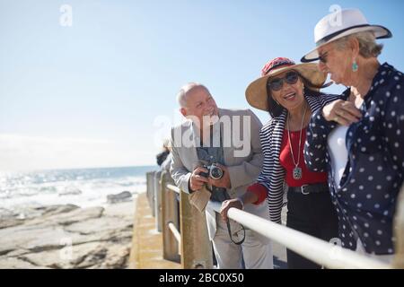 Aktive Senioren-Tourist-Freunde am sonnigen Meer übersehen Stockfoto