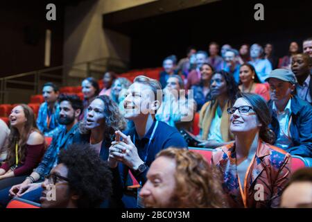 Lächelnder, aufmerksamer Mann im Publikum Stockfoto