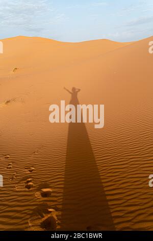 Schatten einer Frau auf Sanddünen in der Sahara, Merzouga, Marokko Stockfoto