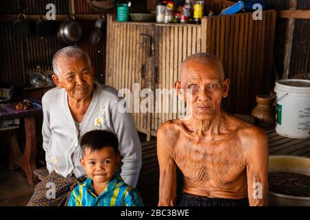 Ein Khmer/kambodianischer Veteran des Südostasienkrieges zeigt seine Tätowierungen in seinem Haus. Stockfoto