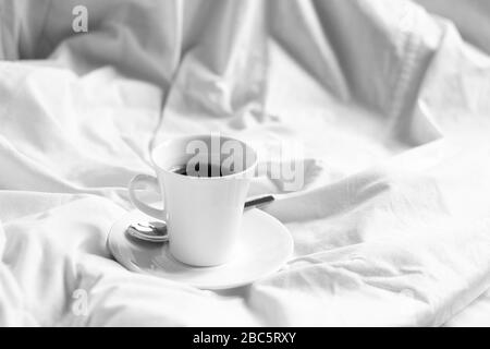 Stillleben der Tasse Kaffee im Bett. Zuhause Bleiben. Stockfoto