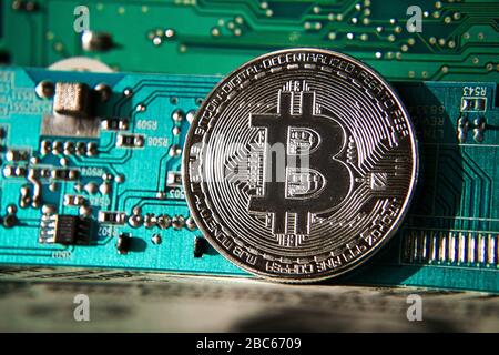 Silber-Bitcoin-Münze vor Computerplatine, Cryptocurrency Mining und Investing-Konzept Stockfoto