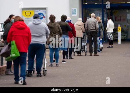 Glasgow, Schottland, Großbritannien. April 2020. Bilder von der Südseite Glasgows am Ende der zweiten Woche des Coronavirus Sperrens. Lange Schlange vor Lidl Supermarkt in Govanhill. Iain Masterton/Alamy Live News Stockfoto