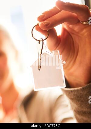 Nahaufnahme einer Person Hand, die den Schlüssel zu einem neuen Haus hält Stockfoto