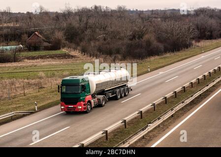 Tank Lkw auf einem ländlichen Land Landstraße oder Autobahn mit Licht Verkehr Stockfoto