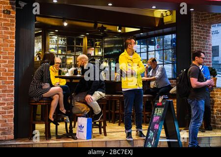 Hongkong, China. April 2020. Die Menschen werden an der Bar in Central, Hongkong getrunken. Die Regierung in Hongkong hat eine zweiwöchige Schließung von Pubs und Bars angeordnet, um die sozial distanzierenden Regeln zu verschärfen. Kredit: Keith Tsuji/ZUMA Wire/Alamy Live News Stockfoto