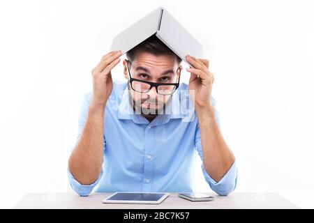 Mann-Betrieb-Laptop über Kopf Stockfoto