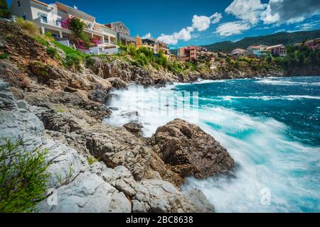 Lange Zeit mit dem malerischen dorf mediterranean Assos, Insel Kefalonia Griechenland. Bunte Häuser am felsigen Ufer. Sommerurlaub. Stockfoto
