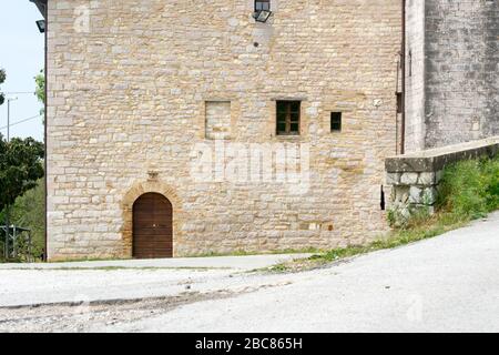 Detail des Eingangs der kleinen Kirche des heiligen Johannes Baptist in Loreto, Umbrien in Italien. Es ist ein guter Ort, um auf der Pilgerfahrt zu stoppen und sich auszuruhen Stockfoto