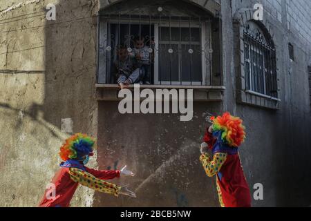 Khan Yunis, Palästina. April 2020. Ein Clown, der eine Gesichtsmaske trug, hielt eine Straßenparade zur Unterhaltung von Kindern palästinensischer wegen der Pandemie des neuen Corona-Virus (COVID-19) in Khan Yunis, südlichem Gazastreifen, Palästina, am 3. April 2020. (Foto von Yousef Masoud/INA Photo Agency/Sipa USA) Credit: SIPA USA/Alamy Live News Stockfoto