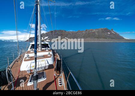 Segelboot in der Antarktis, Yacht-Navigation durch Eisberge und Meereis. Stockfoto