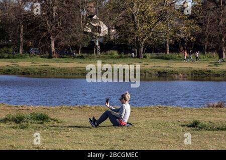 Wimbledon, London, Großbritannien. April 2020. Die Menschen genießen den Sonnenschein und machen an diesem Wochenende in Wimbledon Common eine Pause von der ständigen Sorge um Coronavirus bei wärmeren Temperaturen. Das Vereinigte Königreich hält sich anscheinend an die Regeln der sozialen Distanzierung, um die Ausbreitung von Covid-19 zu stoppen, trotz der Versuchung, bei sonnigem Wetter zu erlöschen. Wimbledon, Southwest London, England, Großbritannien Credit: Jeff Gilbert/Alamy Live News Stockfoto