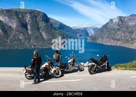 NORWEGEN-CIRCA JUL, 2018: Die Gruppe von Motorradfahrern hält an einem sonnigen Tag an einem malerischen Aussichtspunkt in den Bergen an. Die Menschen fahren mit Motorrädern auf den Straßen Stockfoto