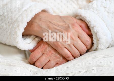 Nahaufnahme der Hände einer alten Frau, die sich über den anderen gefaltet hat. Ältere Frau mit gefalteten Händen. Stockfoto