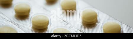 Blister mit gelben Vitaminen in Nahaufnahme, Seitenansicht. Stockfoto
