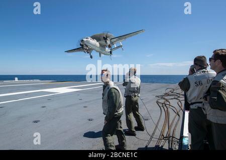 Landessignalbeamte beobachten ein E2-D Advanced Hawkeye, das an die "Greyhawks" des Carrier Airborne Early Warning Squadron (VAW) 120 angeschlossen ist, und landen während des Flugbetriebs am 2. April 2020 auf dem Flugdeck von USS Gerald R. Ford (CVN 78). Ford ist im Atlantik unterwegs und führt die Befähigung der Fluggesellschaften durch. (USA Navy-Foto von Mass Communication Specialist, 3. Klasse Brett Walker) Stockfoto