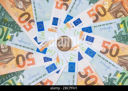 Hintergrund aus Euro-Banknoten und Dollarmünze mit Freiheitsstatue Stockfoto