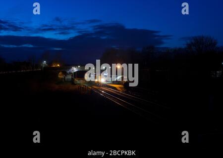 Der Sprinterzug der Nordbahn der Klasse 158 fährt am kleinen Bahnhof Preston mit 2 Bahnhöfen mit einem Zug Morecambe nach Leeds in der Nacht Stockfoto