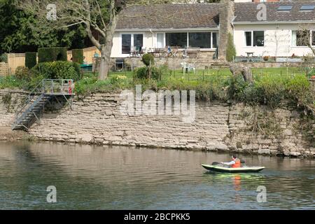 Hereford, Herefordshire UK - Sonntag, 5. April 2020 - EIN Mann paddelt ein aufblasbares Kanu entlang des Flusses Wye im Frühling Sonnenschein für die Bewegung während der Coronavirus-Krise. Foto Steven May / Alamy Live News Stockfoto