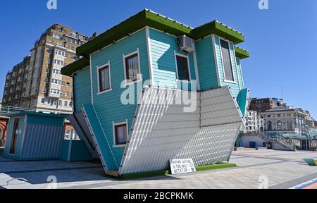 Brighton UK 5. April 2020 - The Upside Down House on Brighton Seafront and Beach an einem warmen sonnigen Tag mit Temperaturen, die während der Coronavirus COVID-19-Pandemie-Krise voraussichtlich zwanzig Grad in London erreichen werden. Gesundheitsminister Matt Hancock hat heute gesagt, dass sie die Regeln für die Ausübung möglicherweise überarbeiten müssen, da zu viele Menschen die Richtlinien ignorieren. Kredit: Simon Dack / Alamy Live News Stockfoto